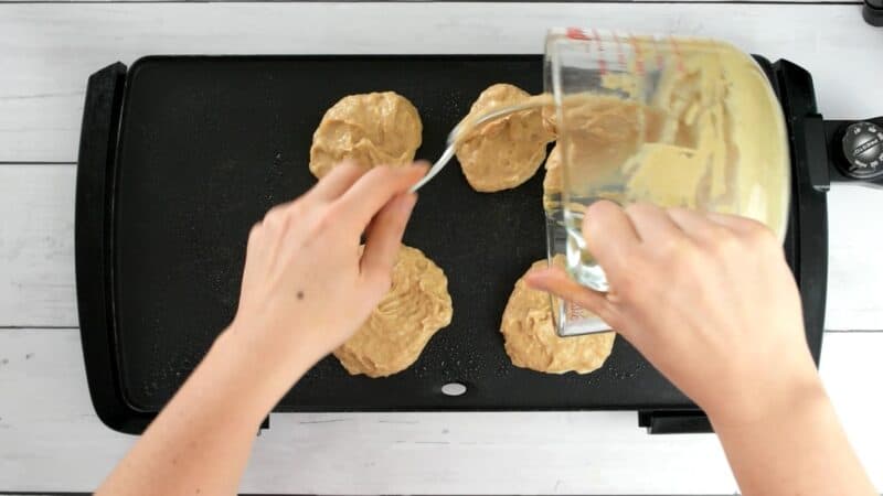 Protein pancake batter being added to a griddle.