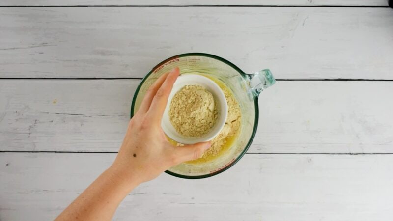 Protein powder being added to bowl.