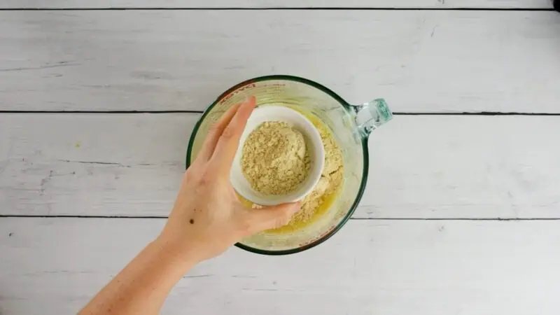 Protein powder being added to bowl.