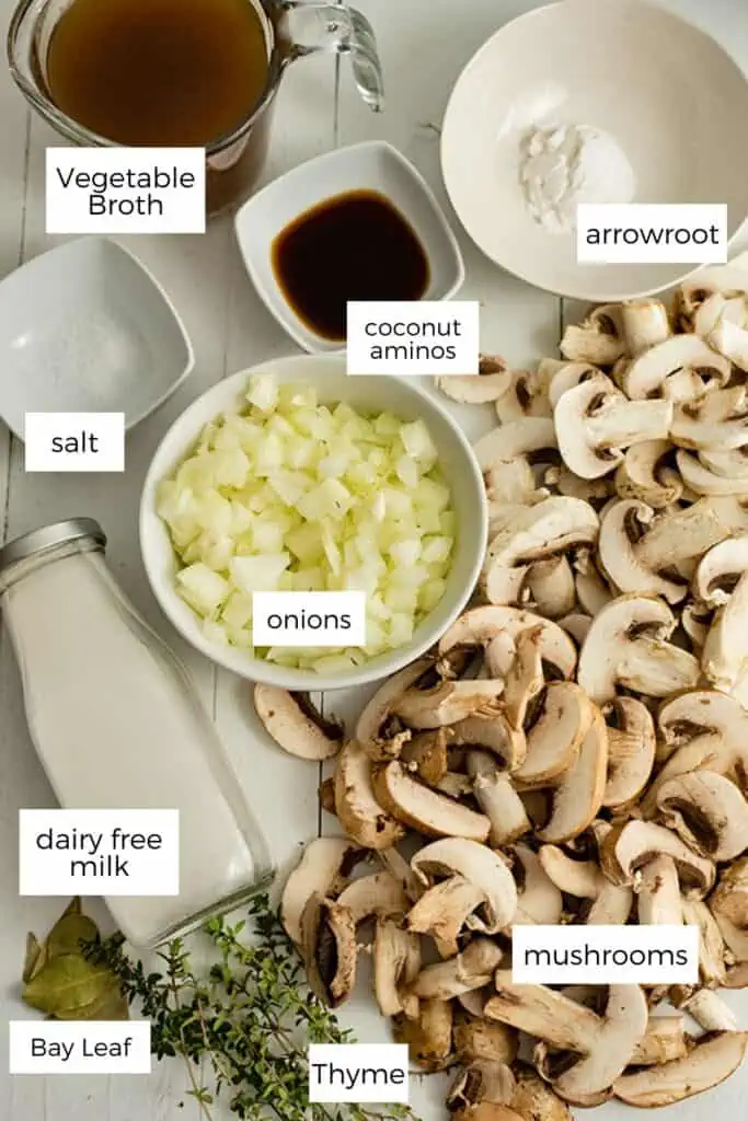 Easy vegan mushroom soup ingredients laid out on a white table.