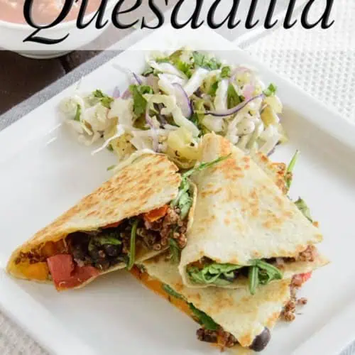 Black Bean Quesadilla with slaw on the side on a white plate