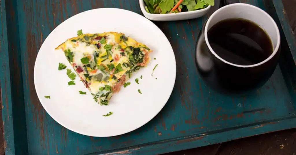 Sliced of egg white frittata with smoked salmon on a white plate. 