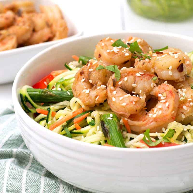 ginger garlic shrimp zoodle bowl packed with shrimp and zoodles