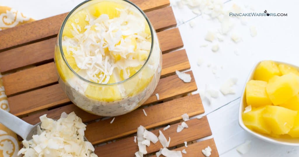 pina colada chia pudding with pineapple chunks and coconut flakes