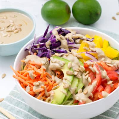 vegan pad thai with carrots, bell peppers, avocado and red cabbage with peanut sauce