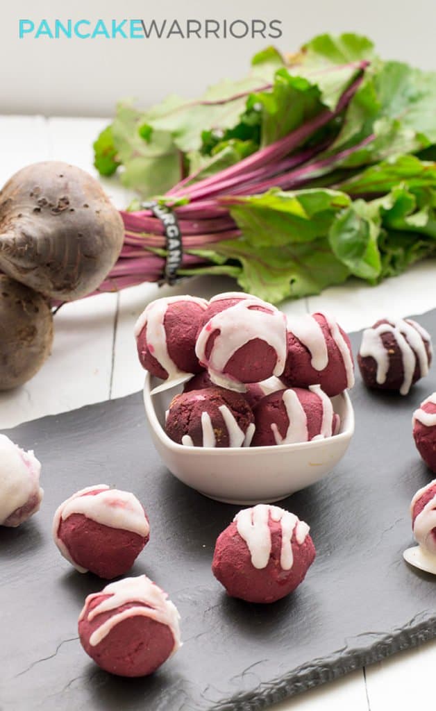 Red velvet protein bites drizzled with coconut butter piled in a bowl