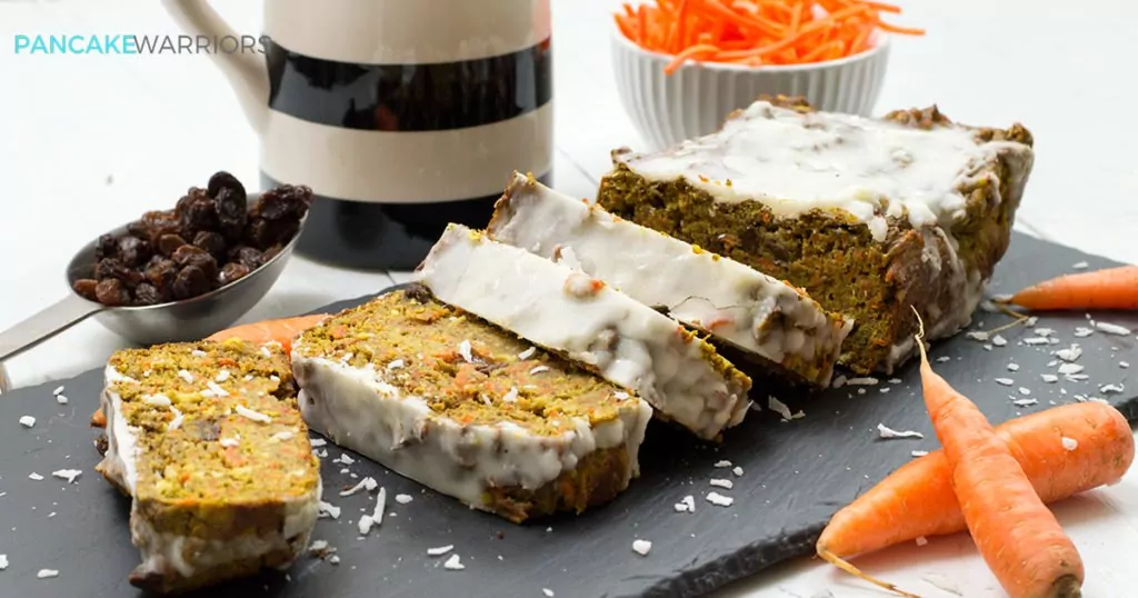 carrot cake banana bread with coconut butter frosting cut into slices