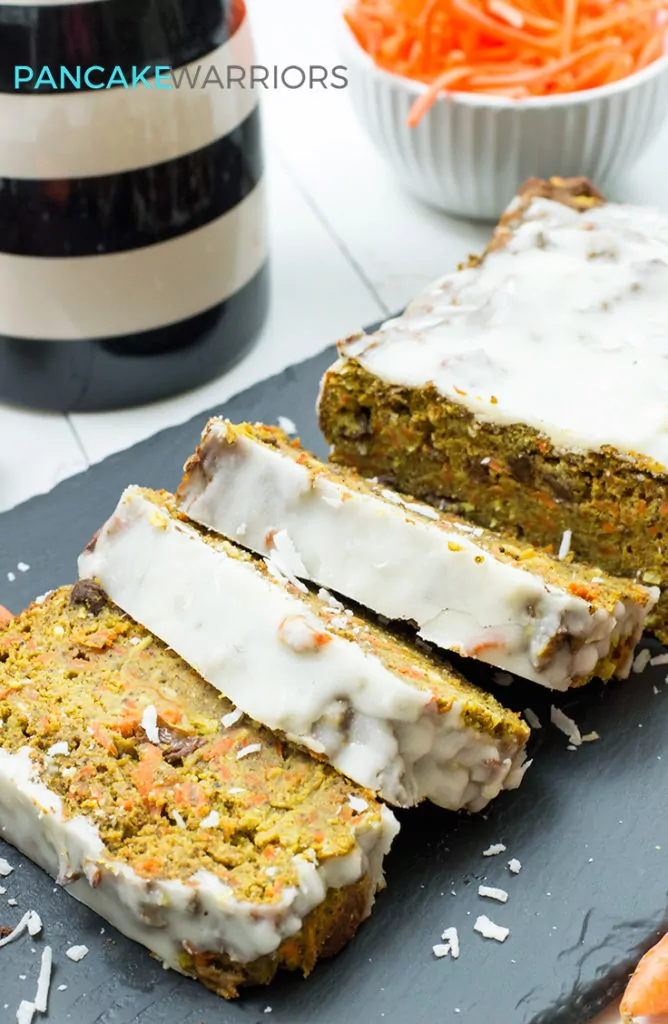 carrot cake banana bread with coconut butter frosting cut into slices
