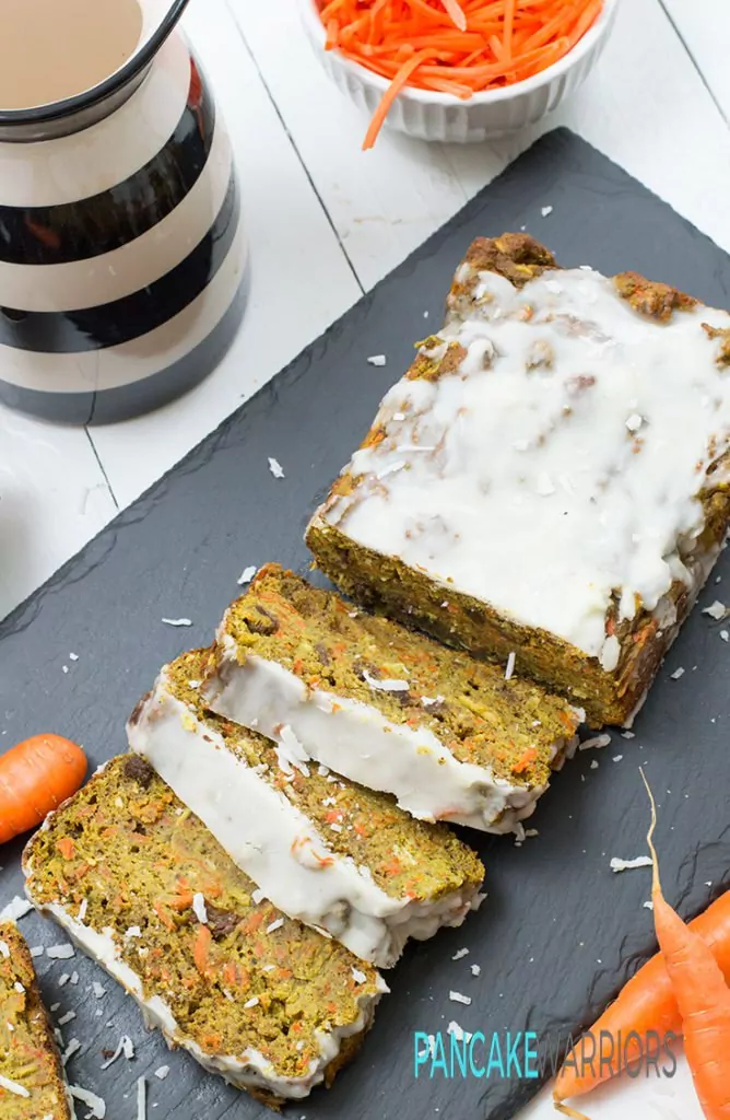 carrot cake banana bread with coconut butter frosting cut into slices