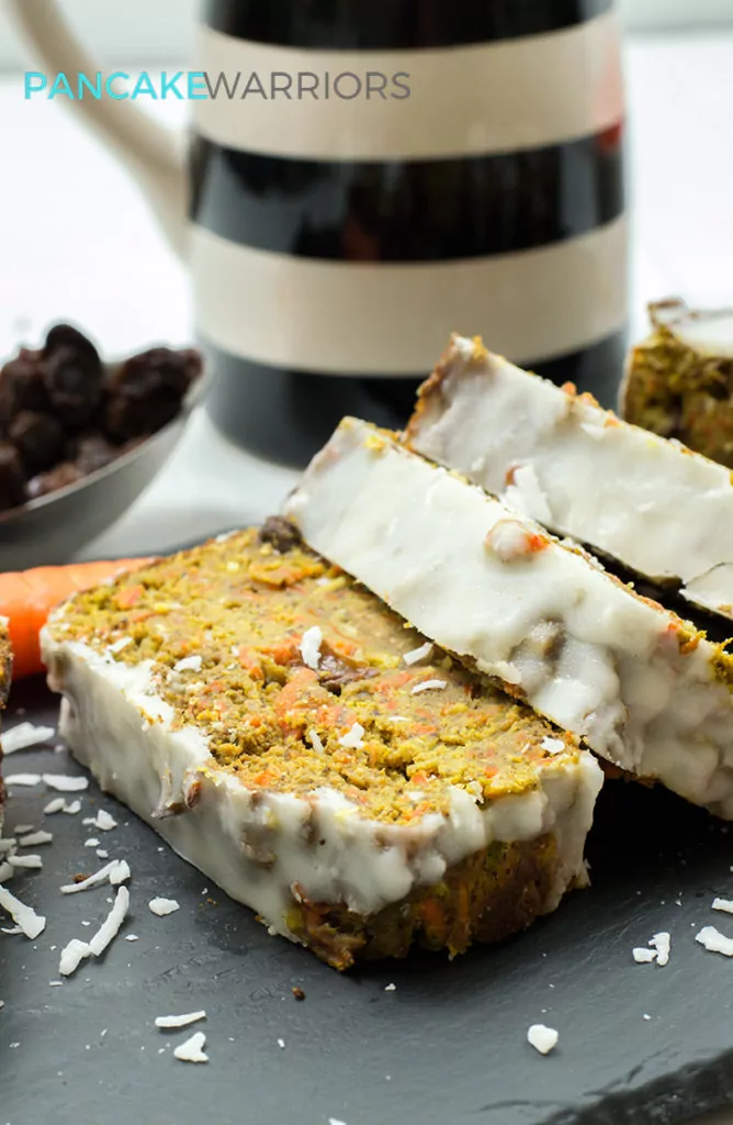 carrot cake banana bread with coconut butter frosting cut into slices