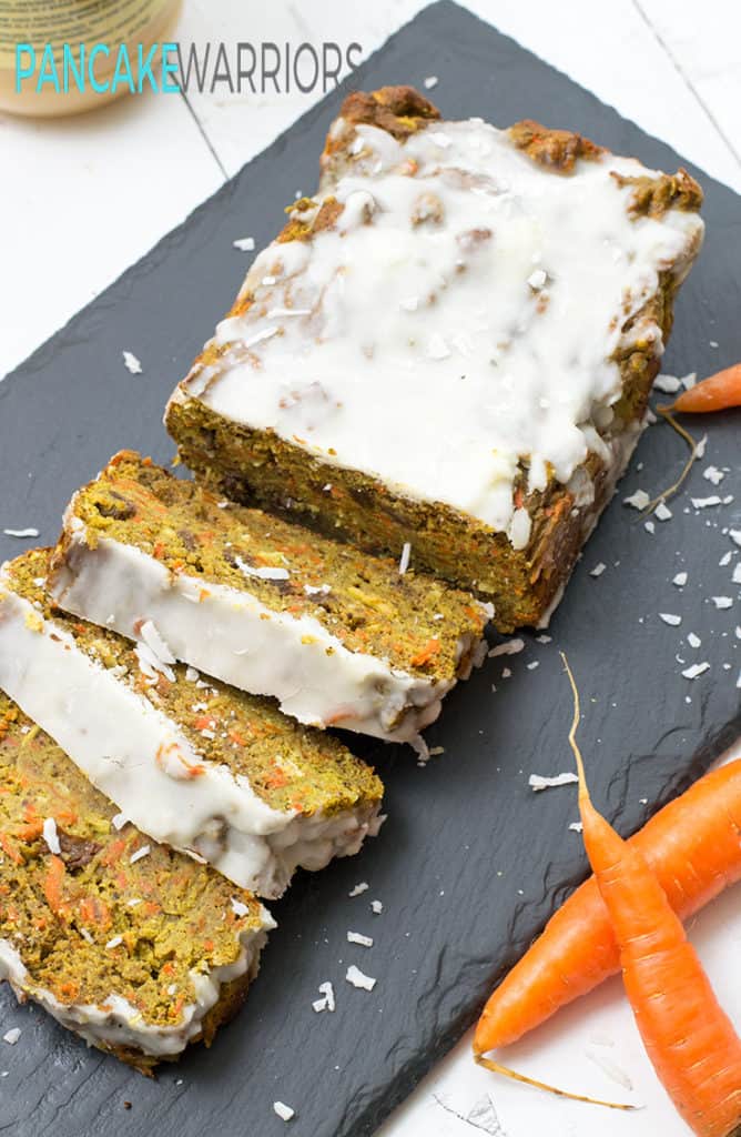 carrot cake banana bread with coconut butter frosting cut into slices