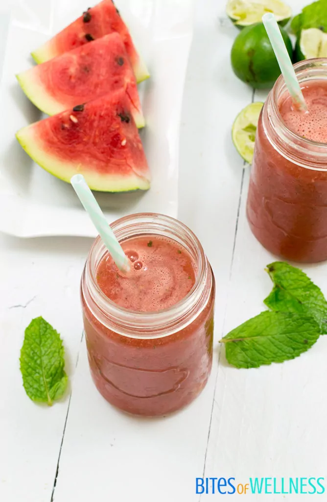 refreshing watermelon mint mocktail in a mason jar with watermelon and limes