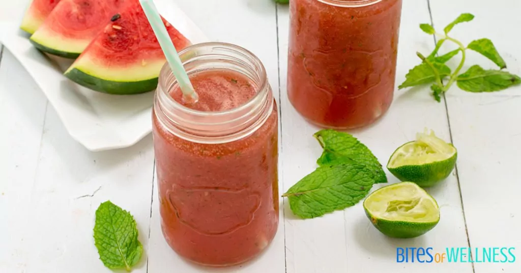 refreshing watermelon mint mocktail in a mason jar with watermelon and limes