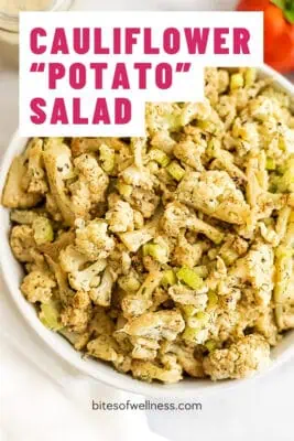 Large white bowl filled with cauliflower potato salad.