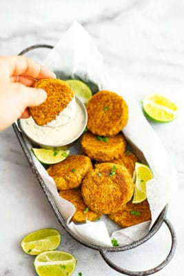 These curried salmon cakes with cilantro lime yogurt sauce are perfect for lunch or dinner. Simple to make, these are whole30, paleo, grain free and ready in under 30 minutes | bitesofwellness.com.
