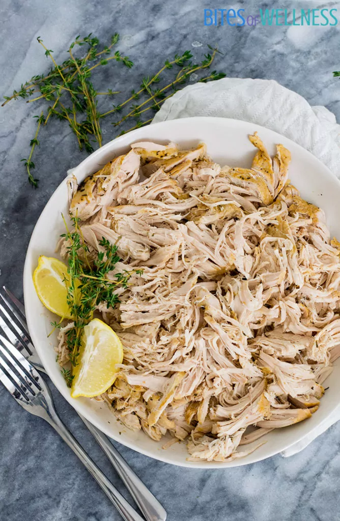Slow cooker shredded chicken recipe on a plate with garnish