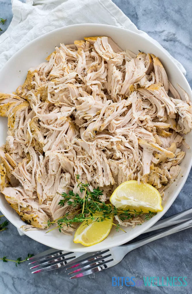 Slow cooker shredded chicken recipe on a plate with garnish