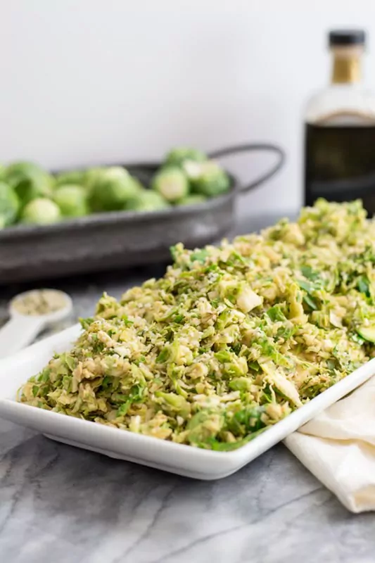 shaved brussels sprouts piled high on a serving dish