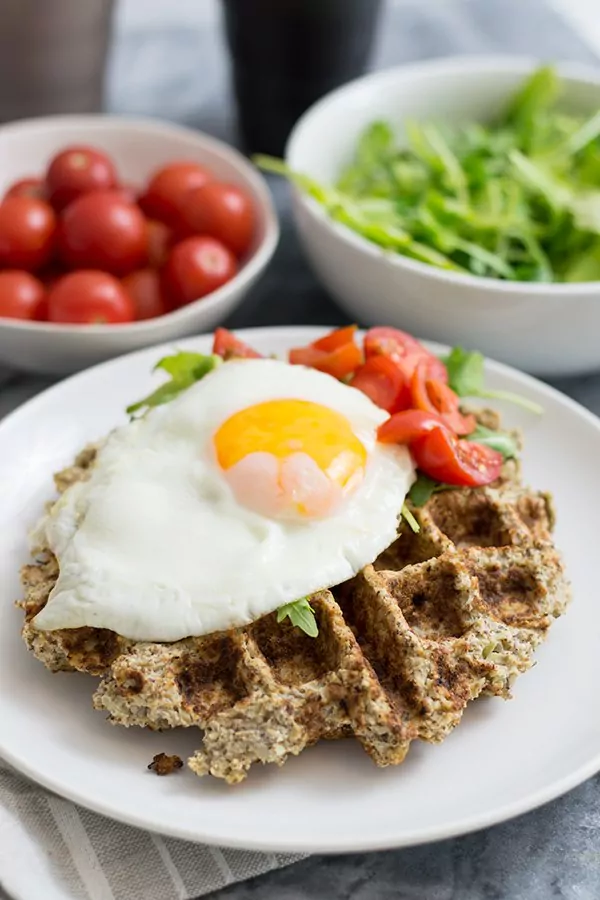 Savory cauliflower waffles with an egg and veggies