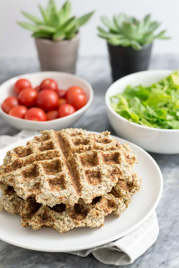 Two savory cauliflower waffles with veggies