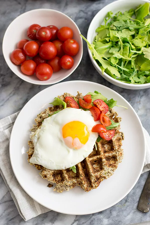 Savory cauliflower waffles with an egg and veggies