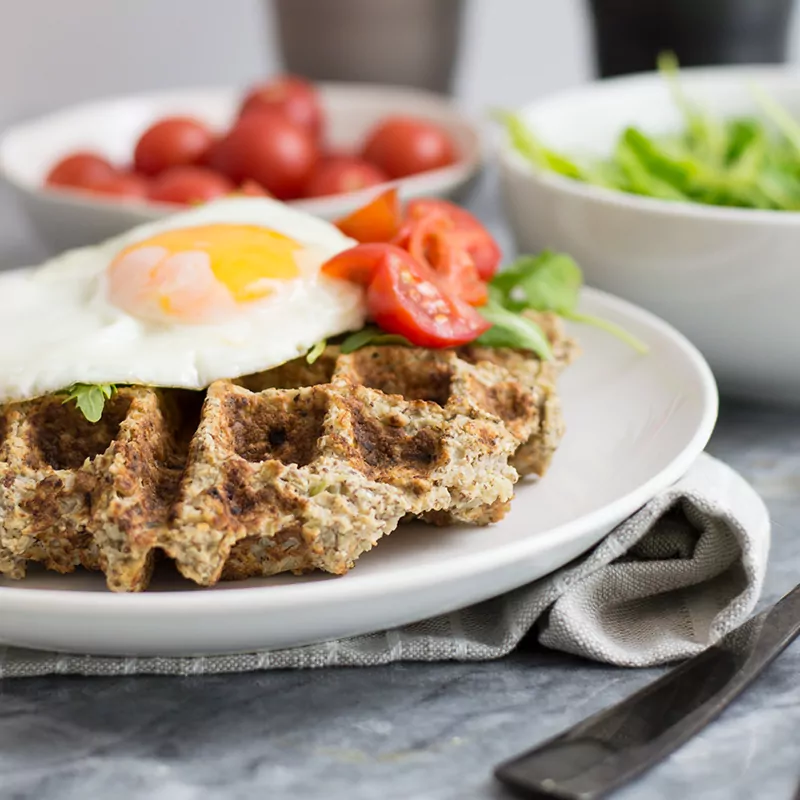 Savory cauliflower waffles with an egg and veggies