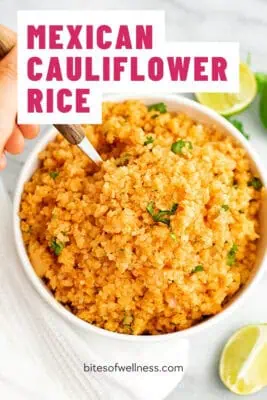 Large bowl filled with Mexican cauliflower rice, spoon resting in the bowl.