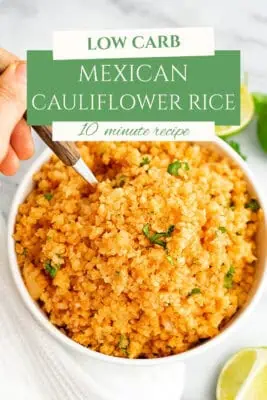 Large bowl filled with Mexican cauliflower rice, spoon resting in the bowl.