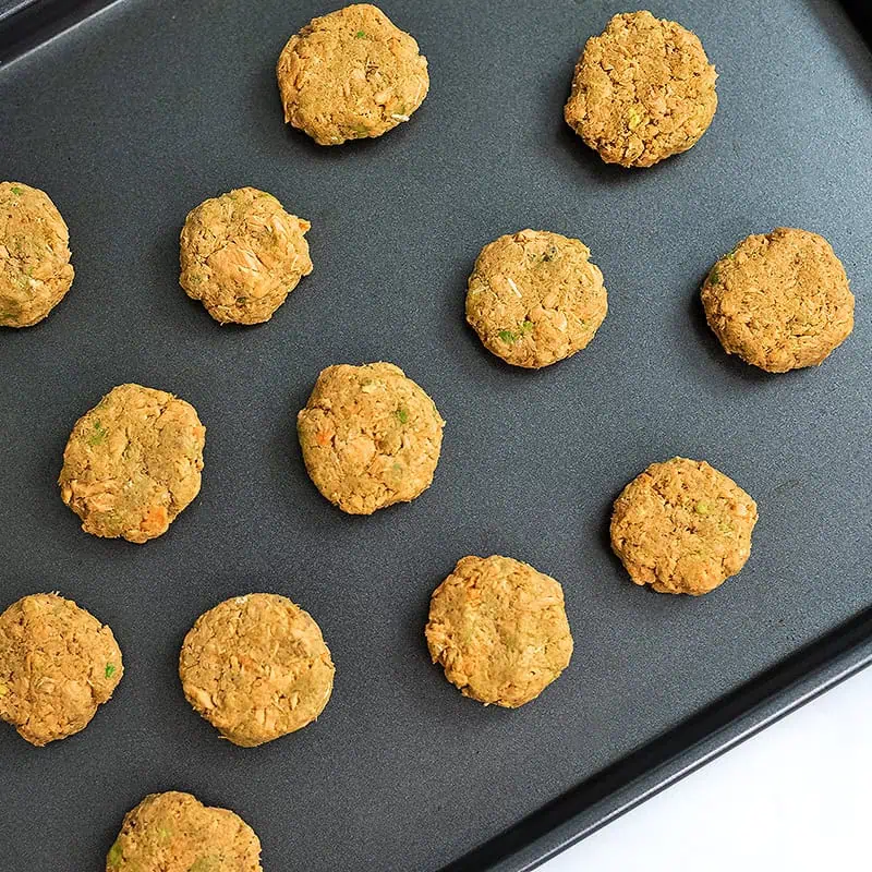 Canned salmon cakes on baking sheet.