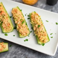 buffalo salmon in cucumber boats on white plate