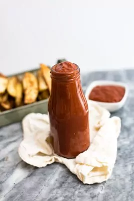 Jar of homemade ketchup on a tan napkin