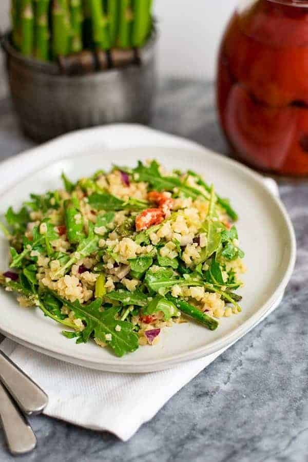 Asparagus Salad with creamy tahini dressing on an white plate 