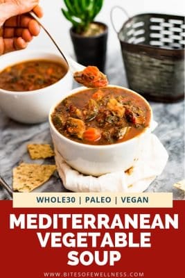 Mediterranean Vegetable Soup in a white bowl with spoon of soup overhead
