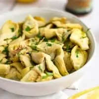 Delicious lemon artichokes in a white bowl