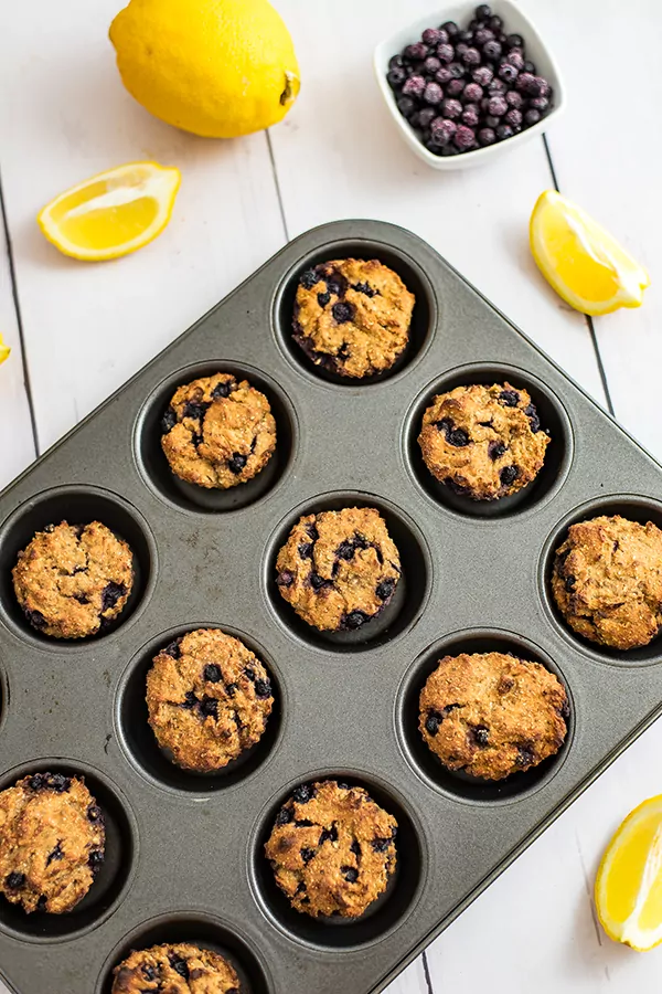 Overhead shot of a muffin tin full of lemon blueberry muffins