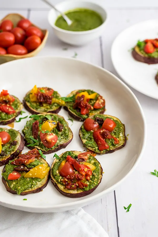 Sweet potato pizaa bites on a large round white plate 