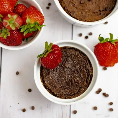 Single serve brownie with a strawberry on top in a white ramekin