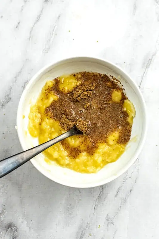Ground flax added to bowl with mashed bananas.