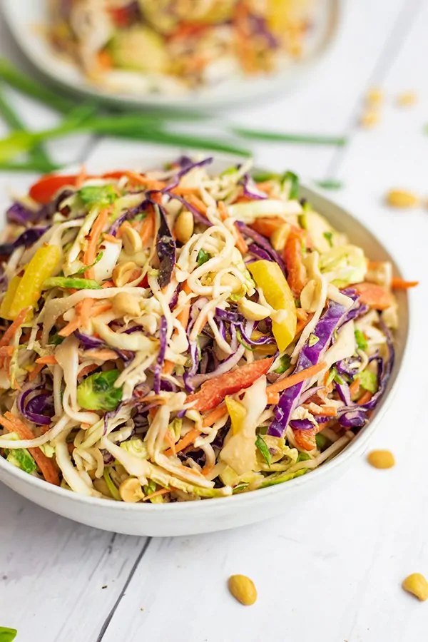 Close up of bowl of Asian Cabbage Slaw with a second bowl in the background
