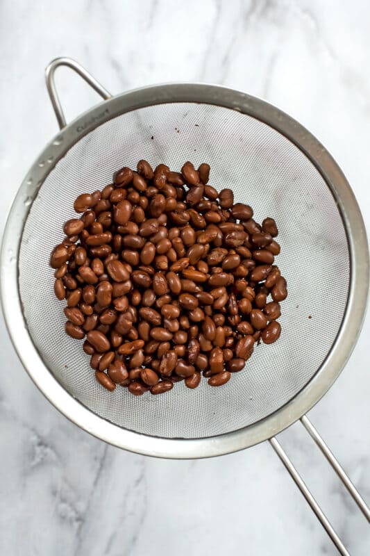 black beans in a mesh strainer.