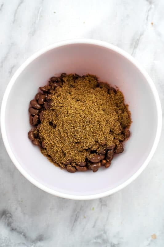 Ground flax and spices added to bowl with black beans.