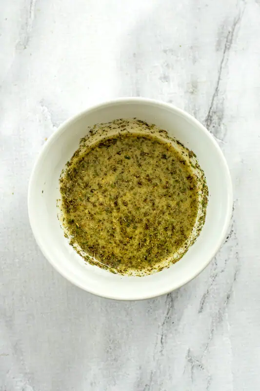 Lemon vinaigrette in white ramekin after mixing.