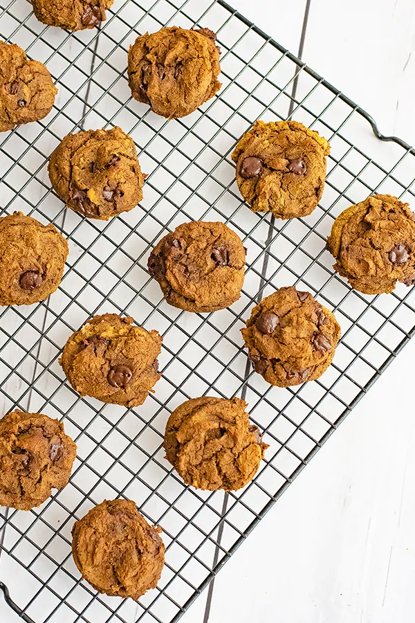 Black wire cooling rack filled with butternut squash chocolate chip protein cookies