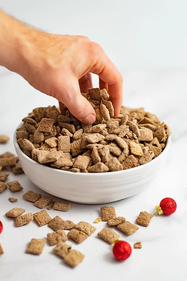 Hand taking a large handful of protein puppy chow