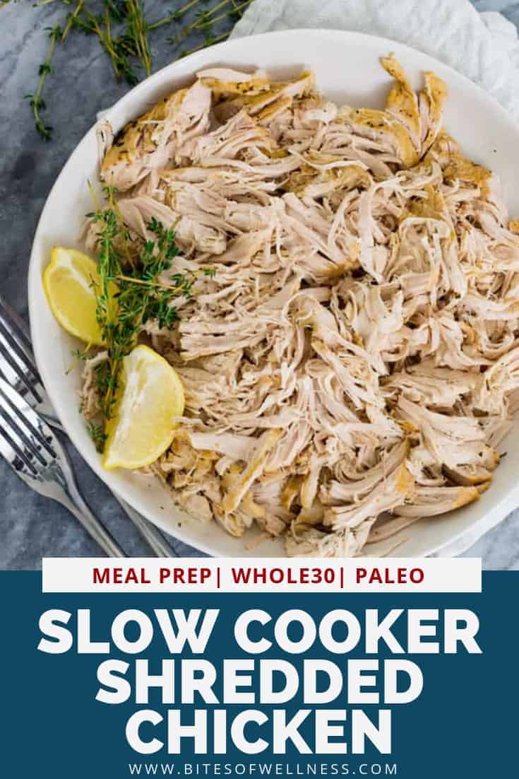 Large white plate filled with slow cooker shredded chicken with a lemon wedge on the plate. Pinterest text below the photo