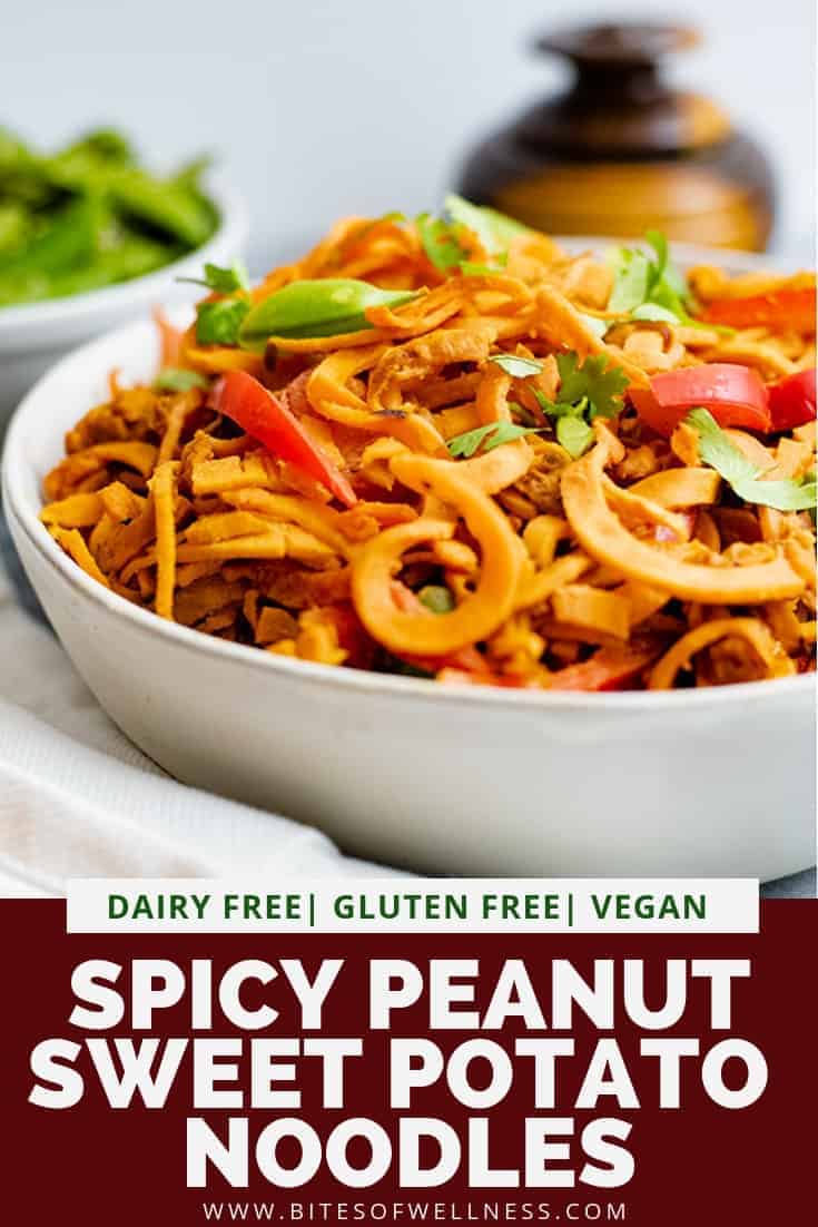 Large bowl of spicy peanut sweet potato noodles with sugar snap peas in a bowl in the background pinterest text on the bottom