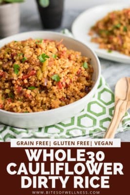 Large white bowl filled with Whole30 Cauliflower Dirty Rice over a green checkered napkin with a wooden spoon on the side. Pinterest text on the bottom