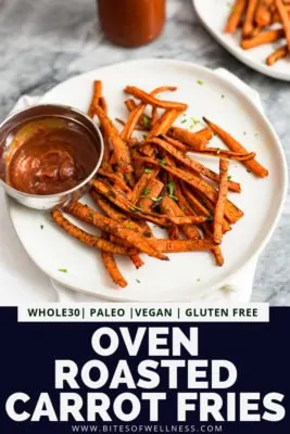 White plate filled with oven roasted carrot fries with a side of ketchup on the plate. Pinterest text on the bottom