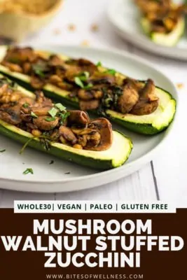 White plate filled with mushroom walnut stuffed zucchini with pinterest text at the bottom