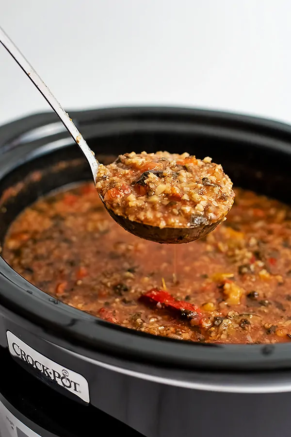 Large ladle full of crockpot low carb vegetable soup